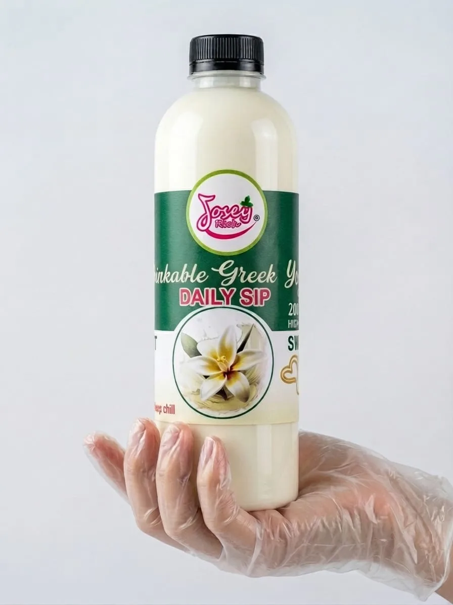 A Josey Rich Daily Sip bottle with a black cap and green label, held in a gloved hand.