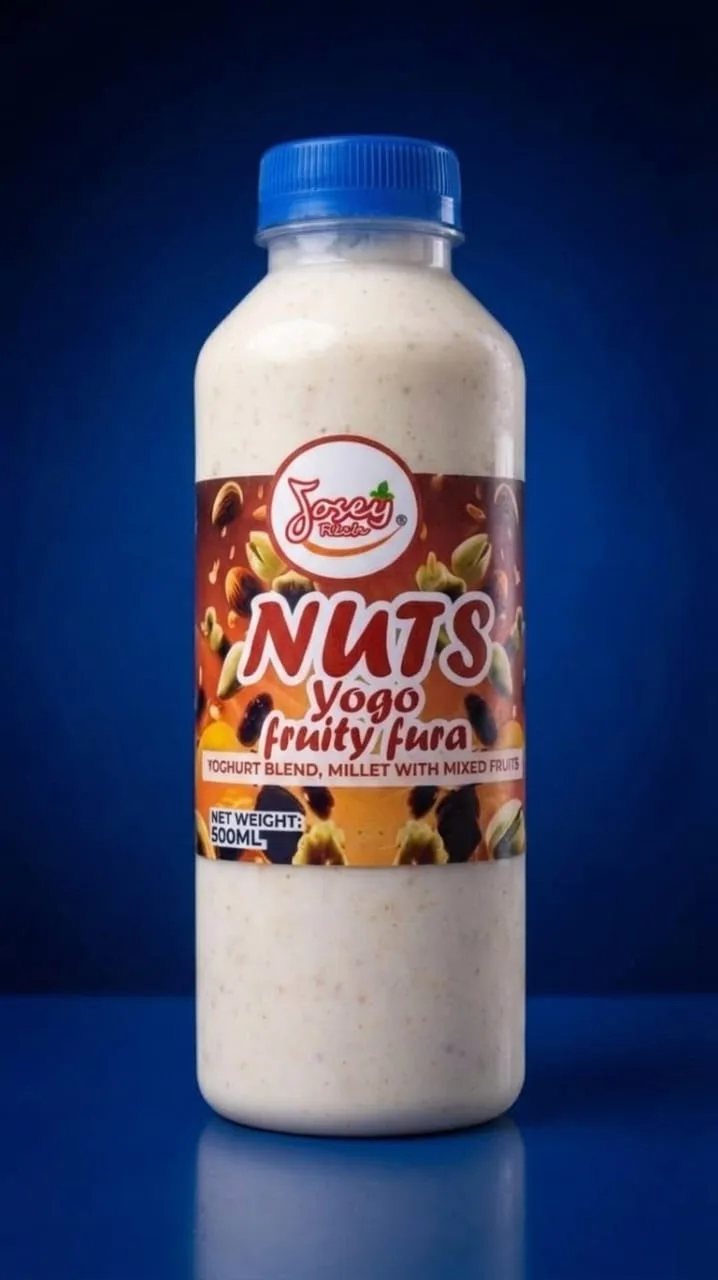 A bottle of Josey Rich Nuts Yogo Fruity Fura with a blue cap on a blue background.