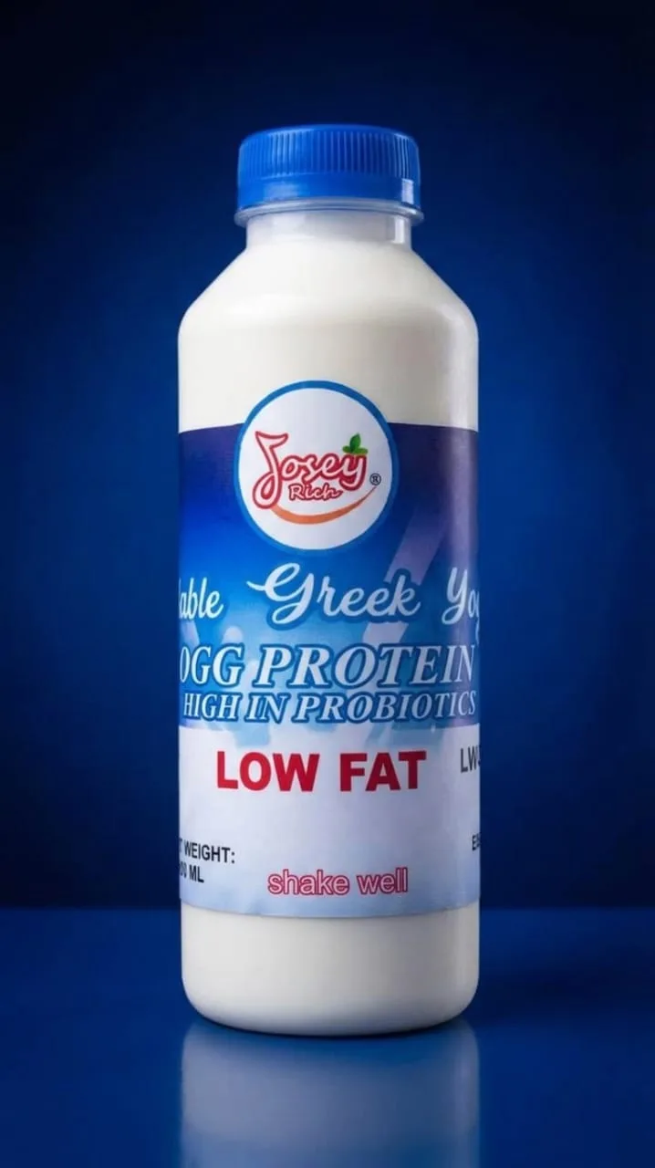 A Josey Rich yoghurt drink bottle with a blue cap and blue-and-white label on a blue background.